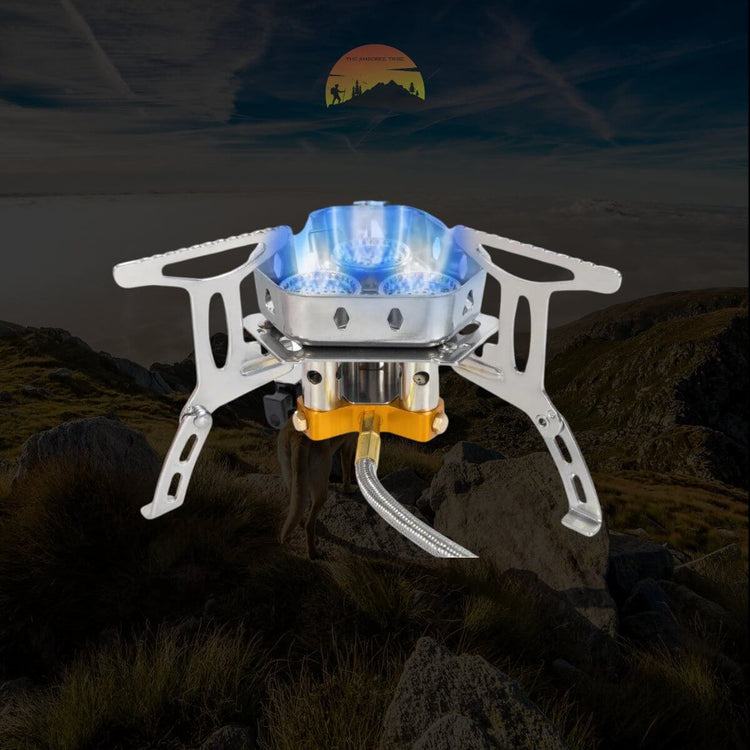 Compact portable camping stove lit up in an outdoor mountain setting with a scenic sunrise background.