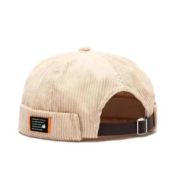 Beige corduroy brimless hat with adjustable strap, soft and durable beanie-style cap for men and women.