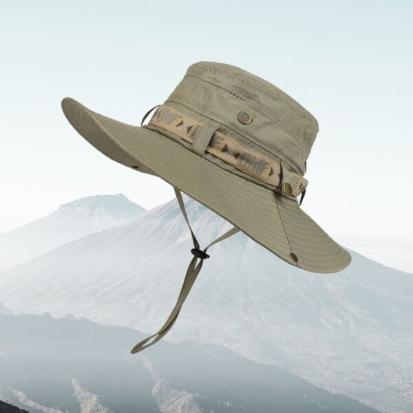 Army green wide brim bucket hat for men, ideal for hiking, fishing, and outdoor sports, with a scenic mountain background.