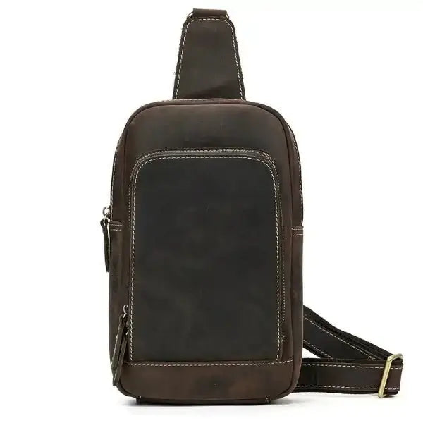 Crossbody sling bag for ladies, brushed leather, carrying strap, metal buckle, top zipper opening, front view, gray background.