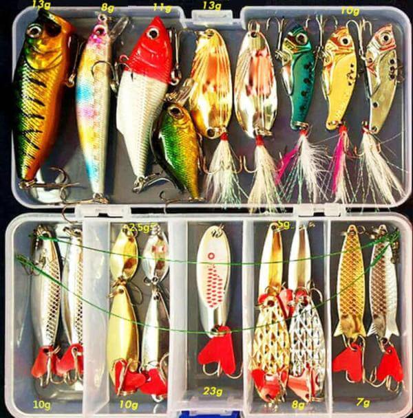Comprehensive fishing tackle box with an assortment of hard baits, crankbaits, spoons, and other fishing lures for sea and fly fishing gear.