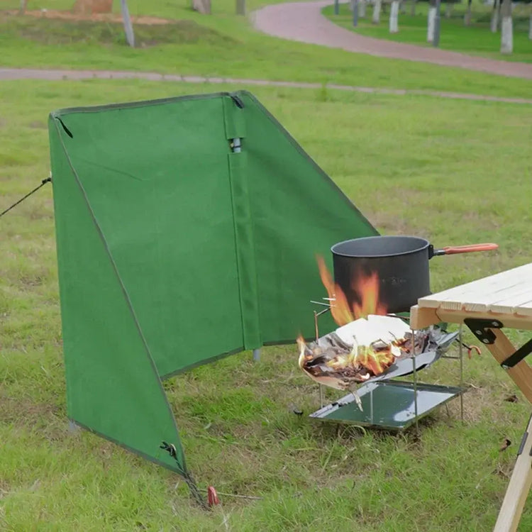 camping stove wind shield foldable design a Durable army green camping stove windshield protecting cooking area from wind outdoors.