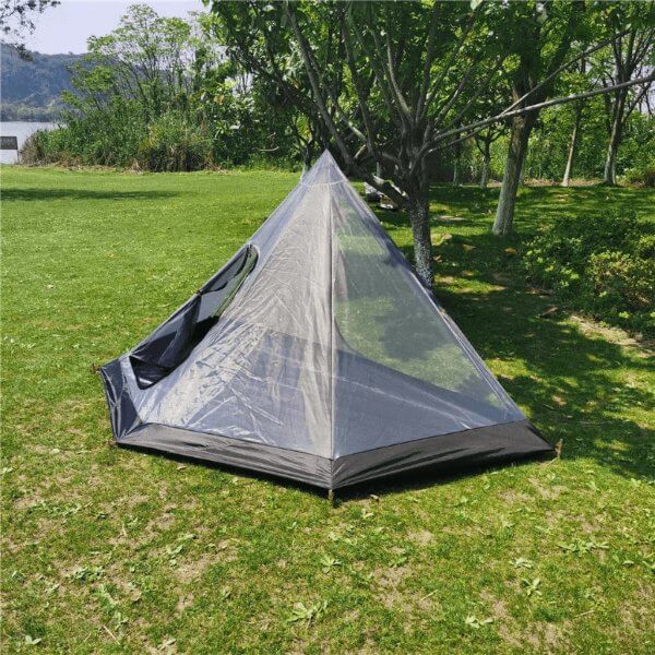 Tingxue 320 Pro ultralight hot tent with floor, 2 person capacity, pyramid-shaped for winter camping and bushcraft in green field.