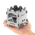 Titanium portable ultralight folding wood stove, ideal for hot tents, backpacking, and camping, held in hand showing its compact size.