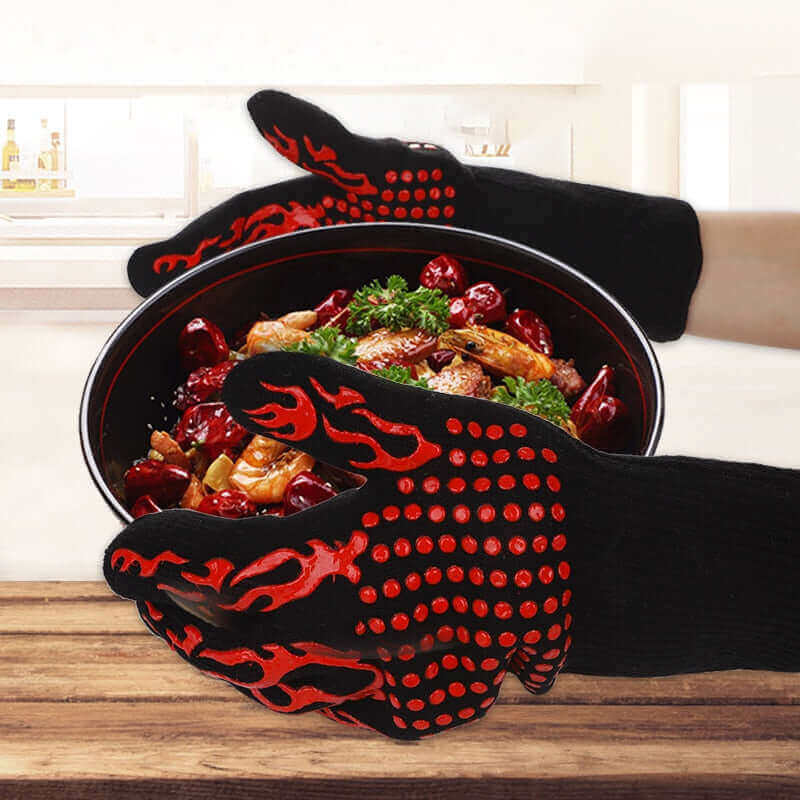 "Person wearing black and red heat resistant BBQ gloves holding a hot pot with cooked food in a kitchen."