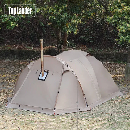 A Top Lander brand tent designed for wood-burning stoves, with a stovepipe hole and a spacious interior, pitched on a grassy lawn.