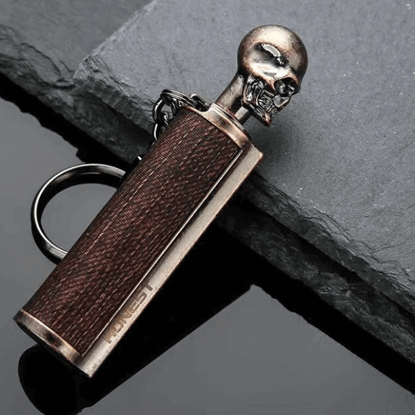 Portable Immortal Stick Match flint lighter keychain with a skull design, perfect for camping and outdoor activities.