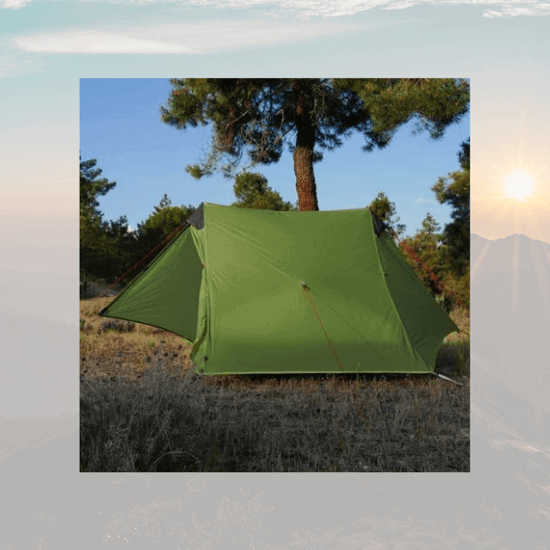 Green ultralight 2-person outdoor camping tent set up in a forest with trees and sunlit sky in the background. Perfect for backpacking trips.