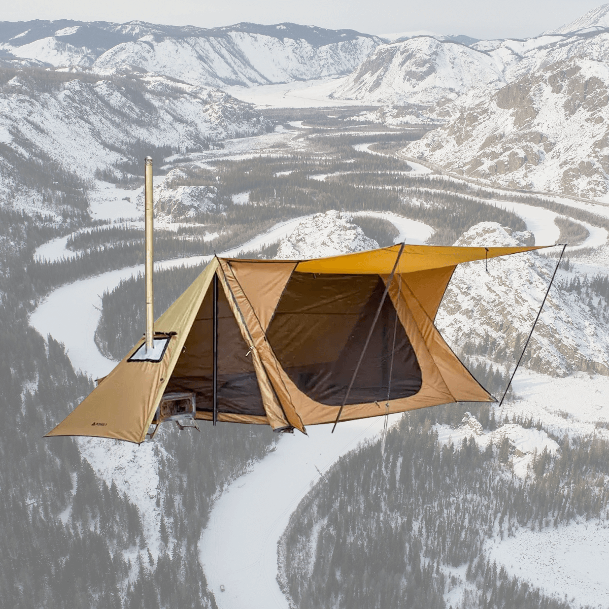 Backpacking hot tent with stove setup, perfect for winter camping, featuring tarp poles against a snowy mountain backdrop.