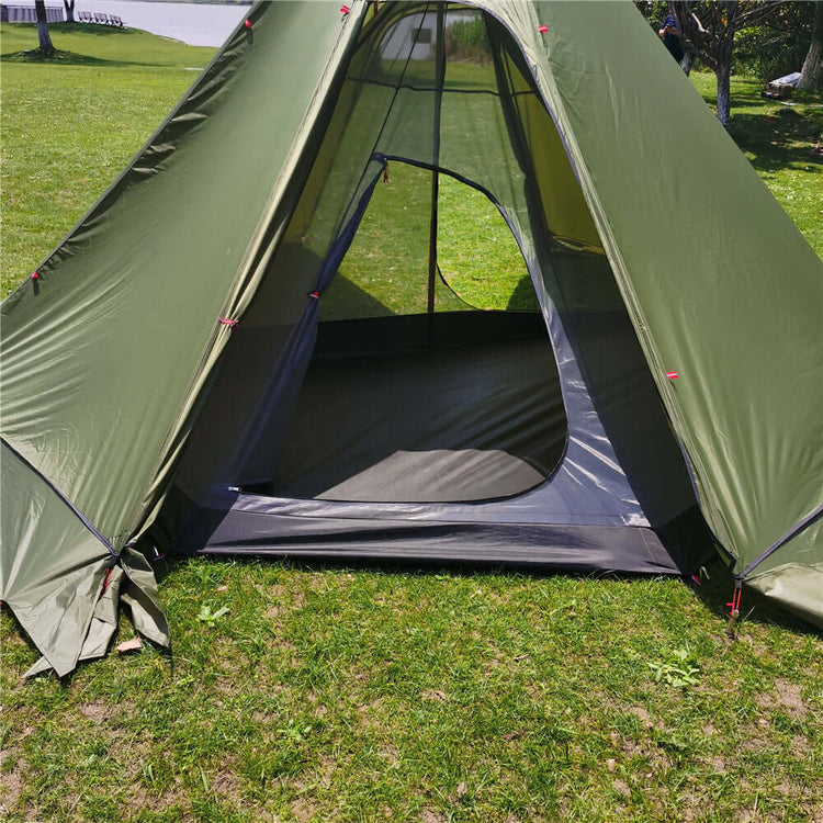 Spacious green winter tent with stove opening, perfect for hot tent camping and winter adventures.