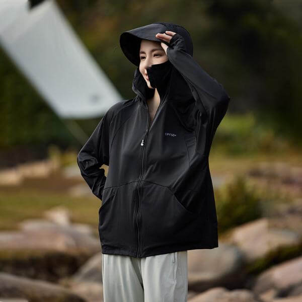 Unisex black sun protective hooded jacket with UPF 50+ fabric, worn outdoors. Perfect for summer and blocks harmful UV rays. Free shipping.