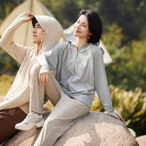 Unisex sun protective hooded jackets in beige and grey, perfect for outdoor sun protection with UPF 50+ fabric. Best hoodies for summer.