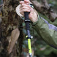 Person holding a Carbon Fiber Folding Walking Stick with 5 sections during a hiking trip.