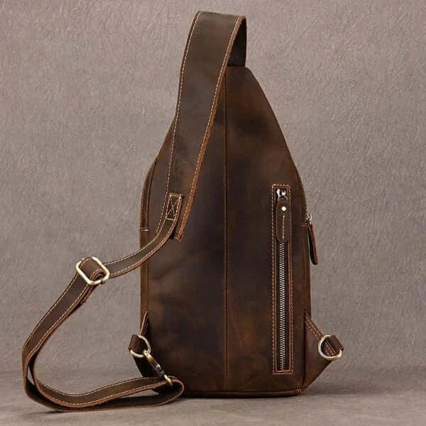 crossbody sling bag with carrying strap, back zipper opening, top and back side view, pointed top shape.