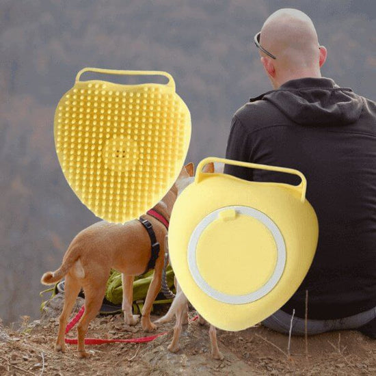 Yellow dog brush with shampoo dispenser for grooming, shown with a man and dog in outdoor setting. Suitable for cats and dogs of all hair lengths.