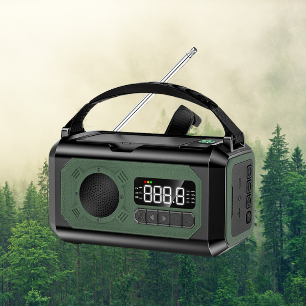 Red radio with solar, electric, and hand crank charging, holding strap, forest background.