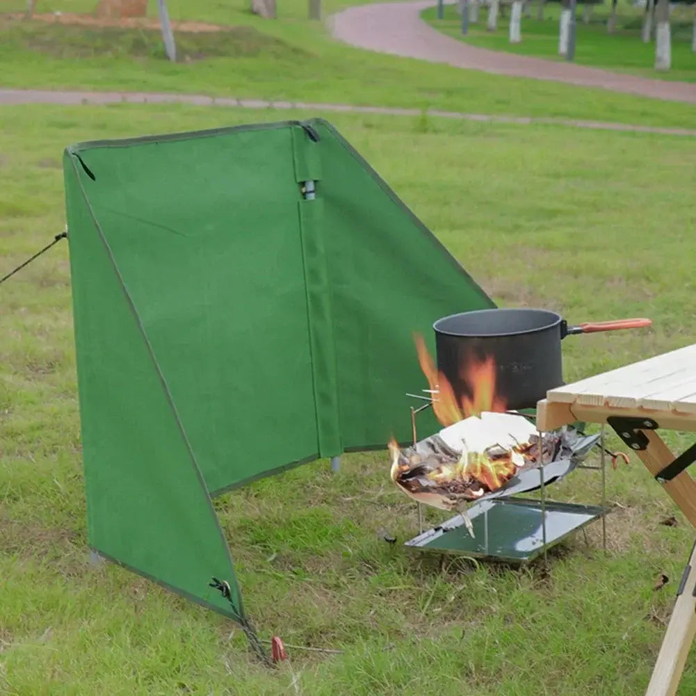 camping stove wind shield foldable design a Durable army green camping stove windshield protecting cooking area from wind outdoors.
