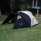 Backpacking tent with stove jack in two-tone black and gray, standing on grass with trees in the background. A modern, weather-ready shelter for cold outdoor adventures.