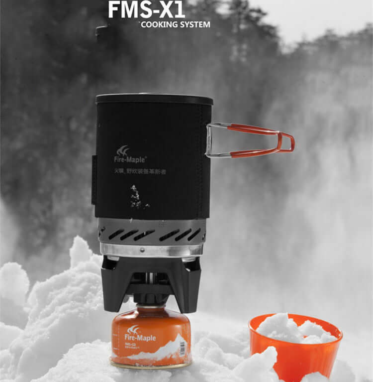 Fire Maple jet boil camp stove on snow, compact and efficient for outdoor cooking, featuring piezoelectric ignition.