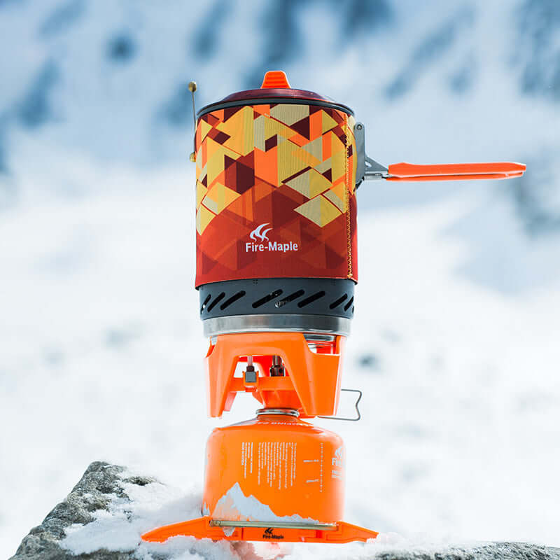 Fire Maple jet boil camp stove for outdoor cooking, snow backdrop, compact and efficient design, perfect for camping adventures.