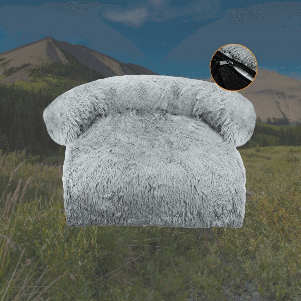 Gray dog bed with arched backrest, background of mountains and green vegetation.