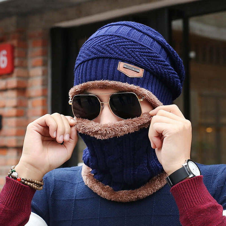 Man wearing a blue wool fisherman beanie with matching thermal fleece neck cover, suitable for cold weather, stylish winter fashion.