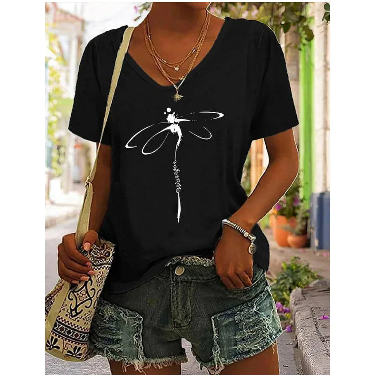 Woman wearing black V-neck graphic tee with dragonfly design, paired with denim shorts, showcasing effortless summer style.