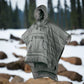 Wearable poncho sleeping bag in a natural outdoor setting, showcasing multifunctional comfort and premium design.