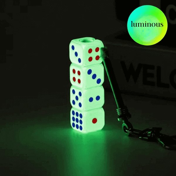 Luminous dice keychain glowing in the dark with stacked white dice and red and blue dots, attached to black keychain.