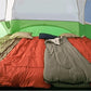 Inner room of tent with sleeping bags arranged neatly.