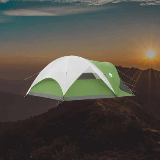 Tents with screen porches for 6 people, showing back of tent with top cover sunset between mountains in the background.