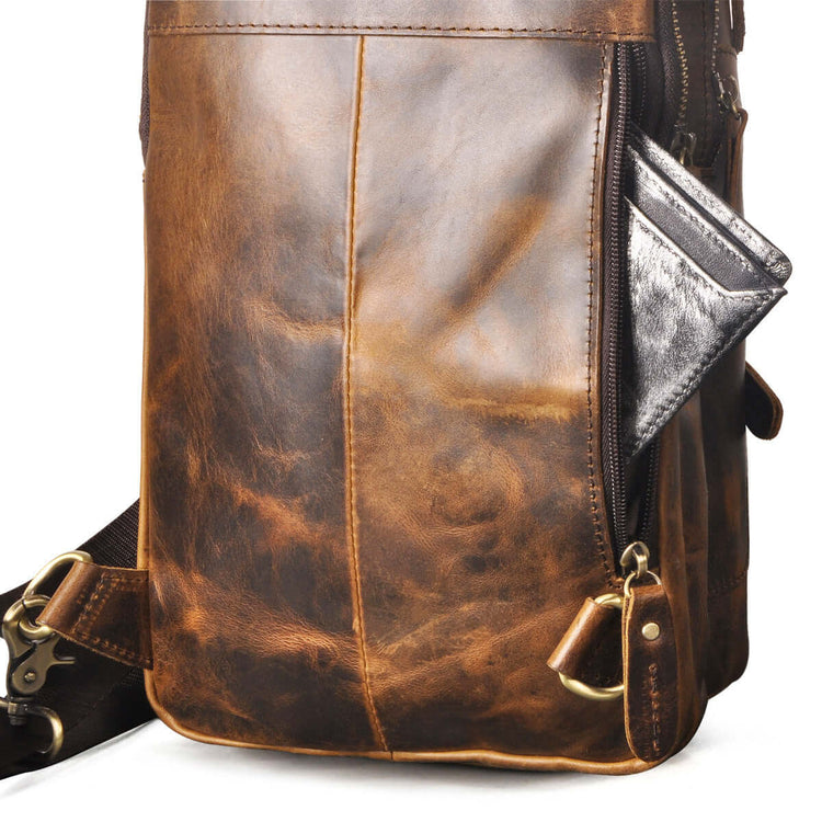 Premium leather sling bag with visible zippers and durable cowhide texture, perfect for men&