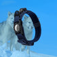 Tactical dog tracking collar with AirTag fixing sleeve in black nylon, perfect for medium-sized dogs, shown with two huskies in a snowy background.