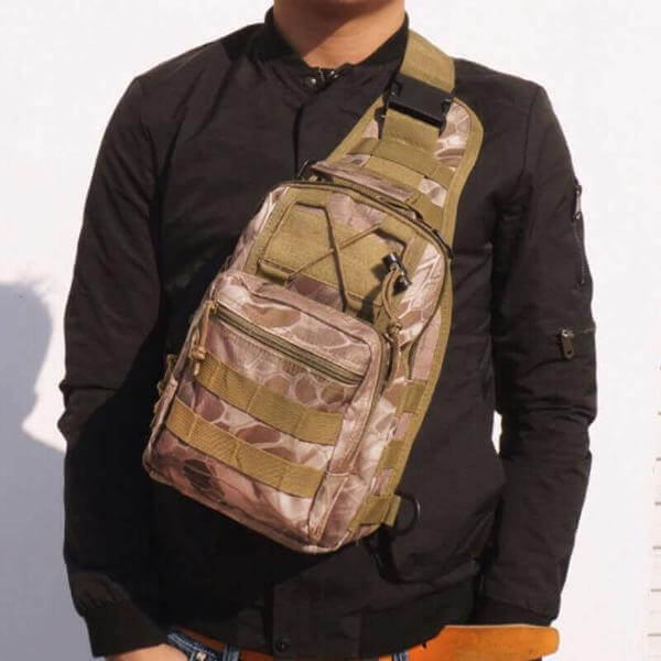 Man wearing versatile outdoor military tactical sling shoulder bag, crafted from rugged 600D Oxford fabric, ideal for hiking and camping.