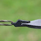 Plastic clip buckle securing rope and fabric, demonstrating tight grip and stronghold, ideal for camping tarps or tents.