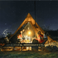 Group camping around a hot tipi tent under a starry night, enjoying warmth and light from a stove, ideal for 2-4 people.
