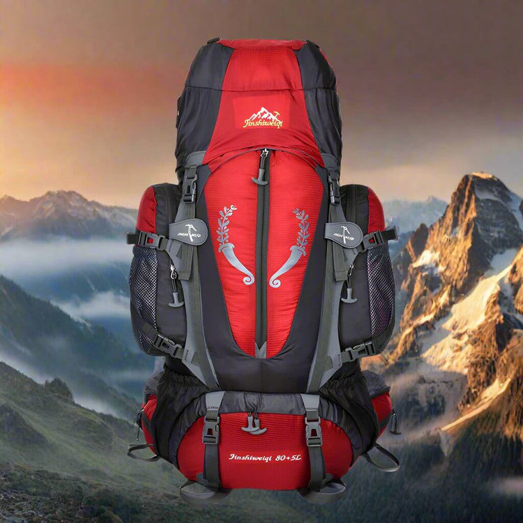 Large red and black hiking backpack for travel with waist strap, in mountain landscape, lightweight and waterproof design