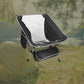 Ultralight folding portable aluminum chair in a scenic camping setting with tent and trees