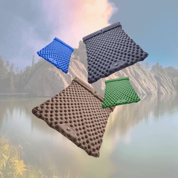 Double inflatable sleeping pad in brown, blue, and green, set against a serene lakeside backdrop.