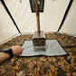 A close-up view of a wood-burning stove inside a tent, with a person&