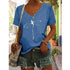 Woman wearing blue V-neck graphic tee with dragonfly design, paired with denim shorts and a boho bag, perfect for effortless summer style.