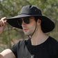 Man wearing black wide brim waterproof safari hat with sunglasses outdoors