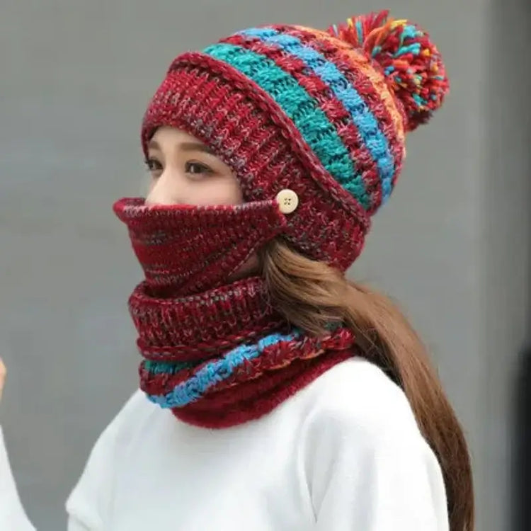 Woman in colorful striped winter beanie and scarf set, featuring pom pom, made of wool, perfect for cold weather and autumn fashion.