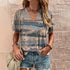 Graphic tees woman, standing next to a wall in t-shirt and shorts, side bag, jewelry on waist and hands.