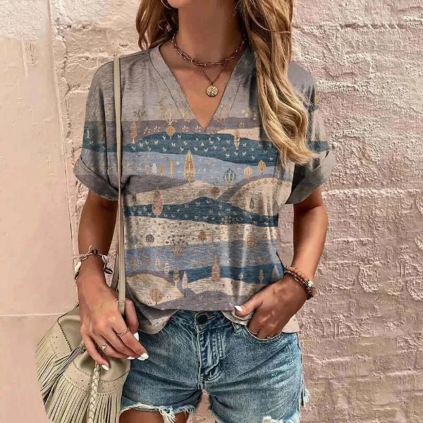 Graphic tees woman, standing next to a wall in t-shirt and shorts, side bag, jewelry on waist and hands.